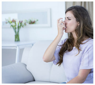 Woman using an inhaler